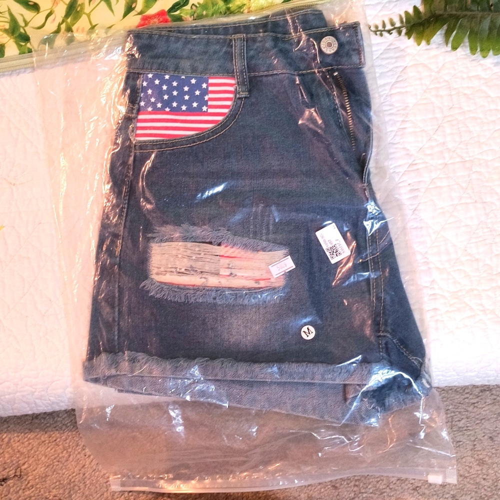 NWT, Denim shorts, rolled up raw hem, featuring American flag on pocket.